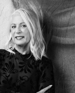 Black and white professional headshot of Julie Young: Developer/Founder with long light hair.